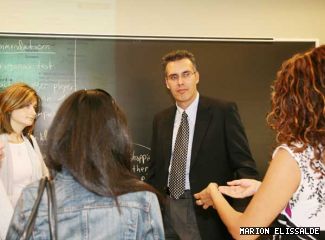 Ron Abraira talks with some of his students after class.